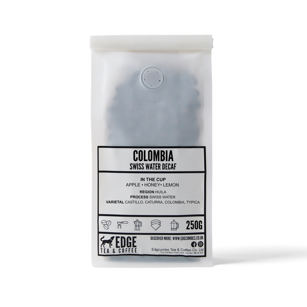 Coffee package labeled 'Colombia Swiss Water Decaf' by Edge Tea & Coffee on a white background